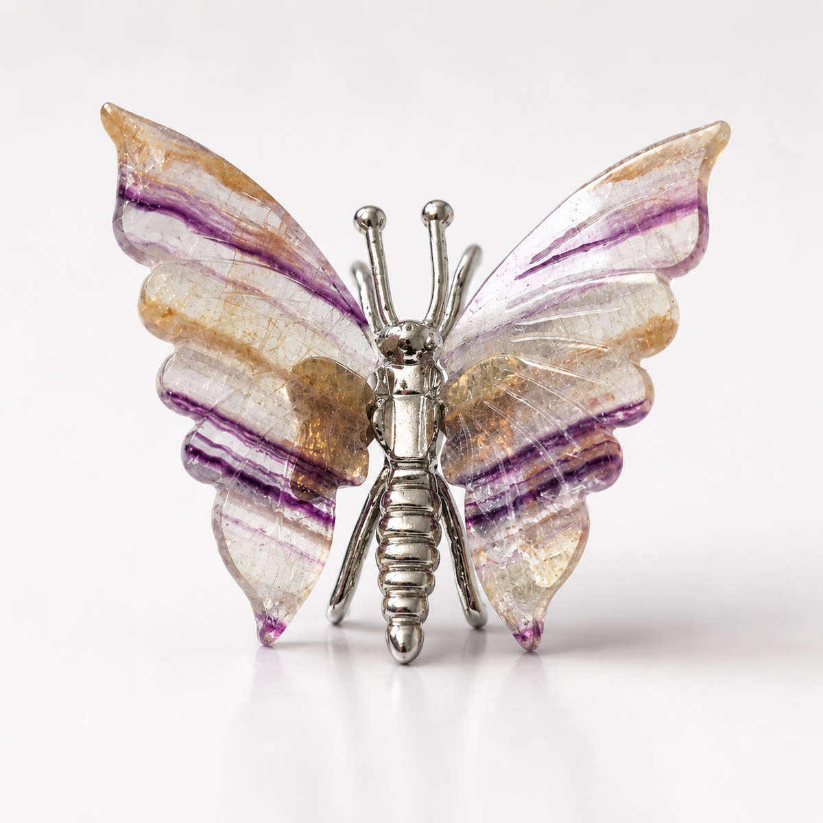Fluorite butterfly crystal carving with natural purple banding