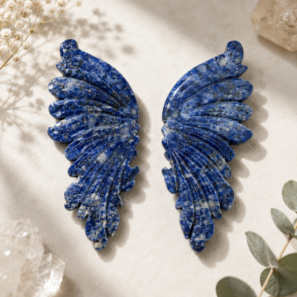 Sodalite crystal wing carving with navy blue and white patterning
