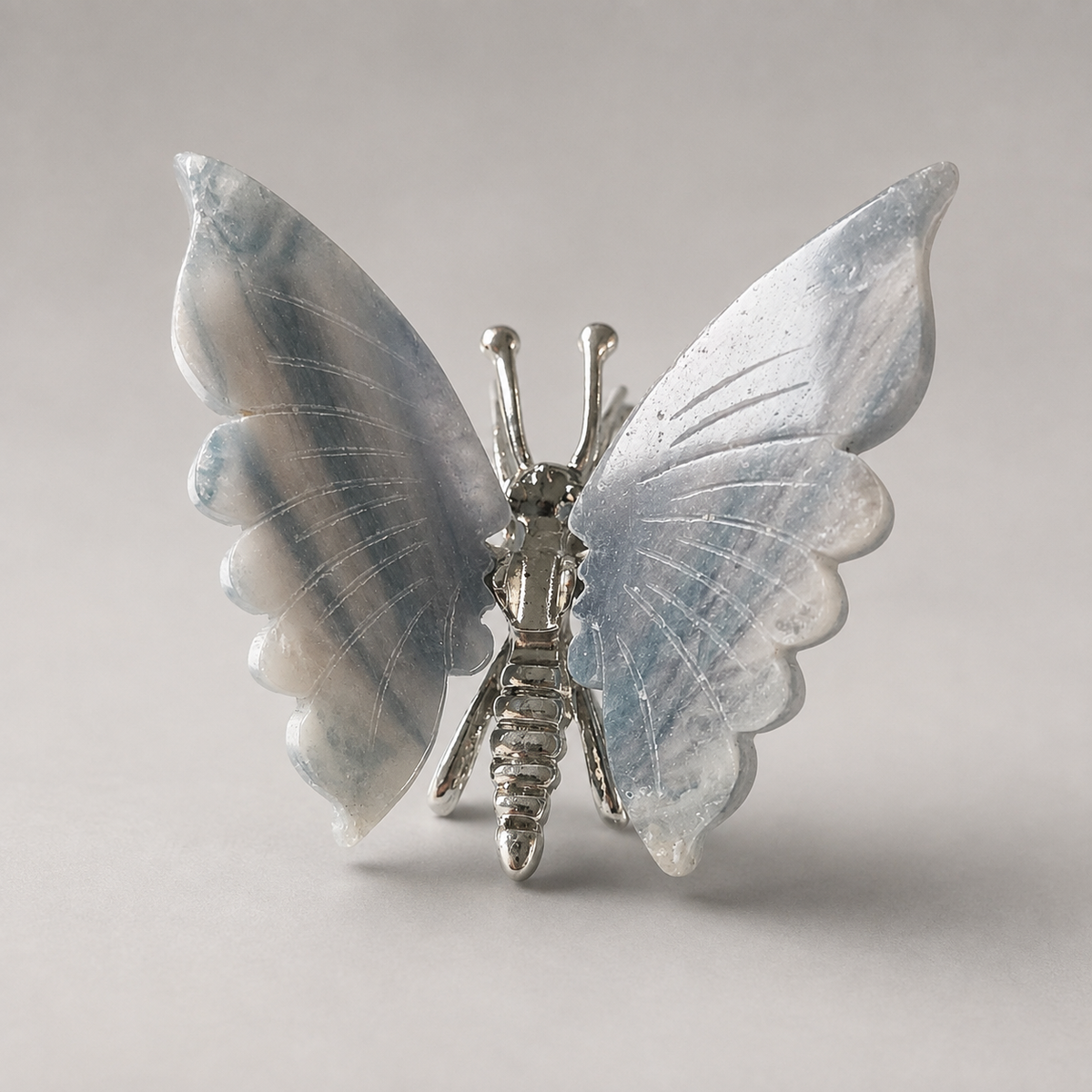 Fluorite butterfly crystal carving with green purple and white banding