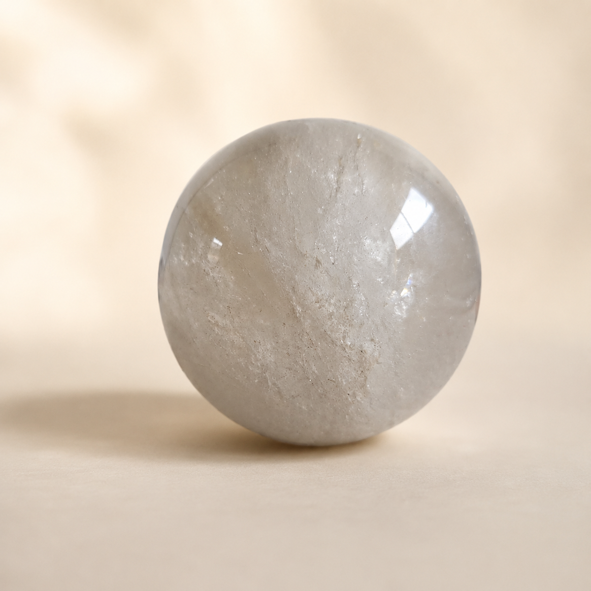 1030g Light Smoky Quartz crystal sphere with translucent grey tones