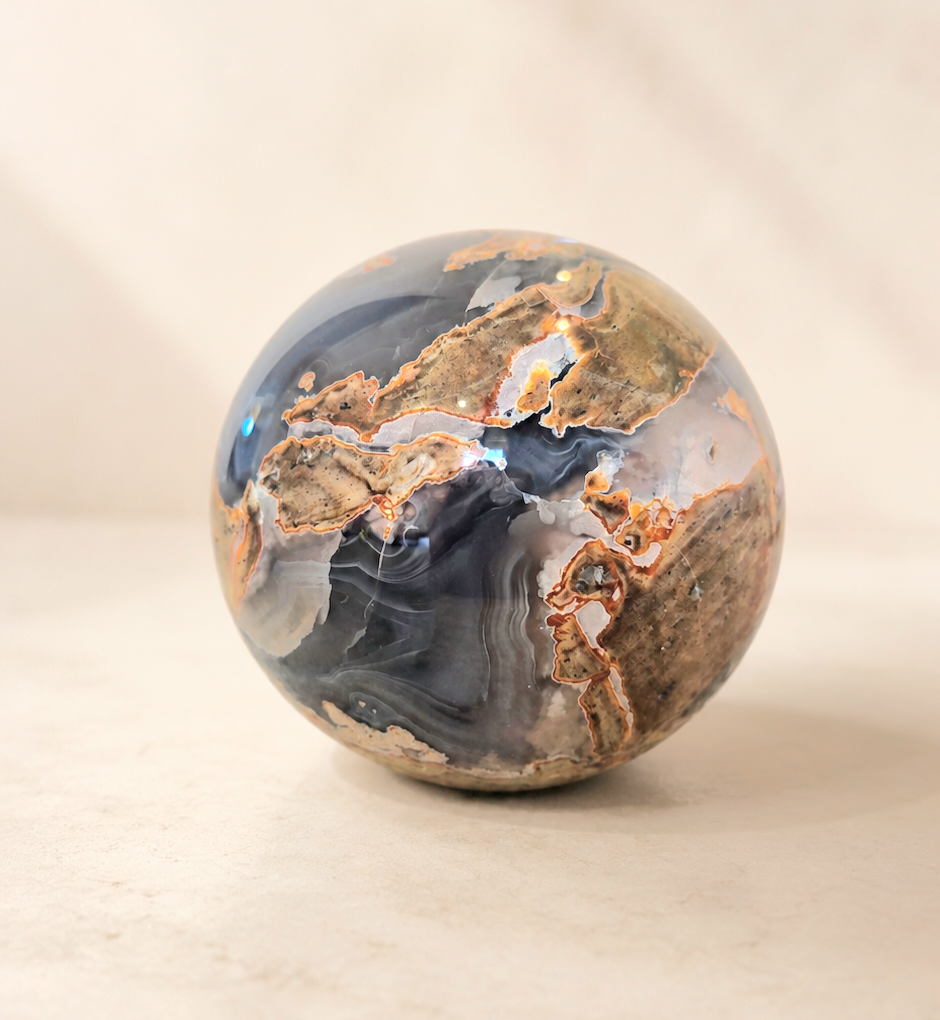 738g Agate crystal sphere with smoky grey and caramel banding