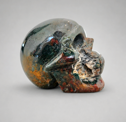 824g Bloodstone skull crystal carving with green and red inclusions
