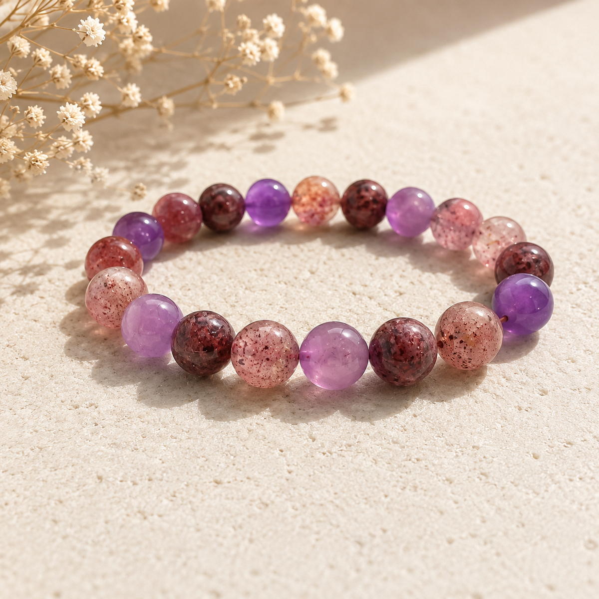 Super Seven polished bead crystal bracelet in purple pink and wine tones